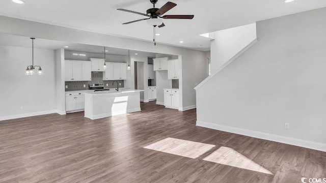 1012 Fowler Rd, Conway, SC 29526 - unfurnished living room with ceiling fan, recessed lighting, dark wood-style flooring, and a chandelier