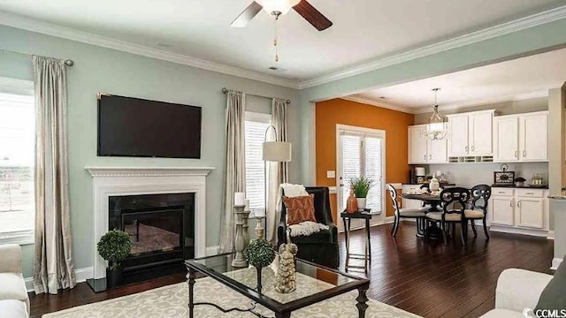 1012 Fowler Rd, Conway, SC 29526 - living room with ceiling fan, dark wood-type flooring, a fireplace with flush hearth, and crown molding