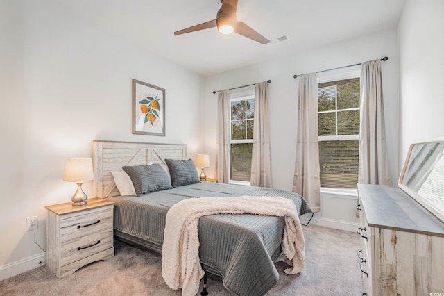 5116 Double Eagle Way Unit 49, North Myrtle Beach, SC 29582 - bedroom with multiple windows, light colored carpet, and ceiling fan
