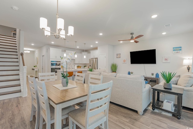 5116 Double Eagle Way Unit 49, North Myrtle Beach, SC 29582 - dining space with light wood-style floors, stairs, recessed lighting, ceiling fan, and a chandelier
