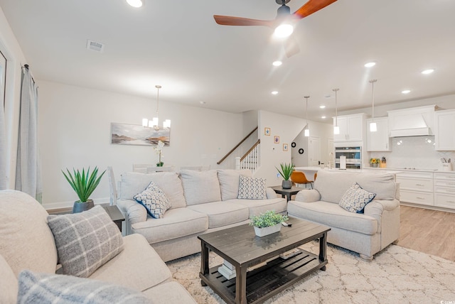 5116 Double Eagle Way Unit 49, North Myrtle Beach, SC 29582 - living room featuring light wood-type flooring, recessed lighting, ceiling fan, stairs, and a chandelier