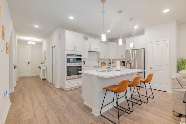 5116 Double Eagle Way Unit 49, North Myrtle Beach, SC 29582 - kitchen with stainless steel appliances, a kitchen breakfast bar, light wood-style floors, and recessed lighting