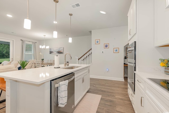 5116 Double Eagle Way Unit 49, North Myrtle Beach, SC 29582 - kitchen with stainless steel appliances, light wood-style floors, a center island with sink, white cabinets, and recessed lighting
