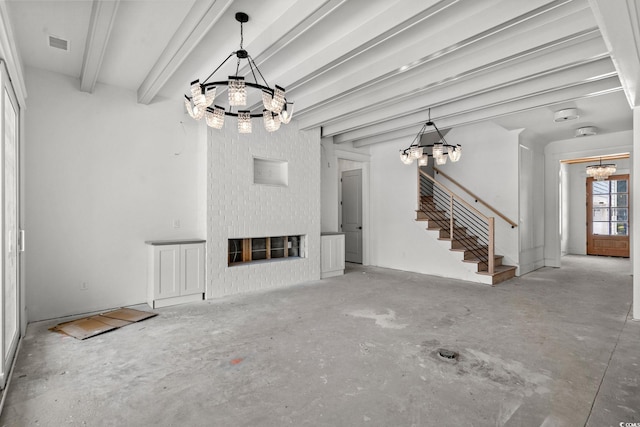 2201 Yellow Morel Way, Myrtle Beach, SC 29579 - unfurnished living room featuring a chandelier, stairway, and a glass covered fireplace