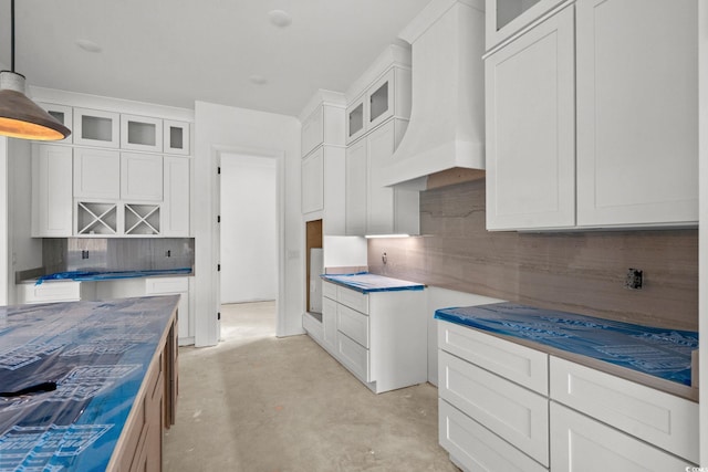 2201 Yellow Morel Way, Myrtle Beach, SC 29579 - kitchen with premium range hood, glass insert cabinets, backsplash, concrete floors, and decorative light fixtures