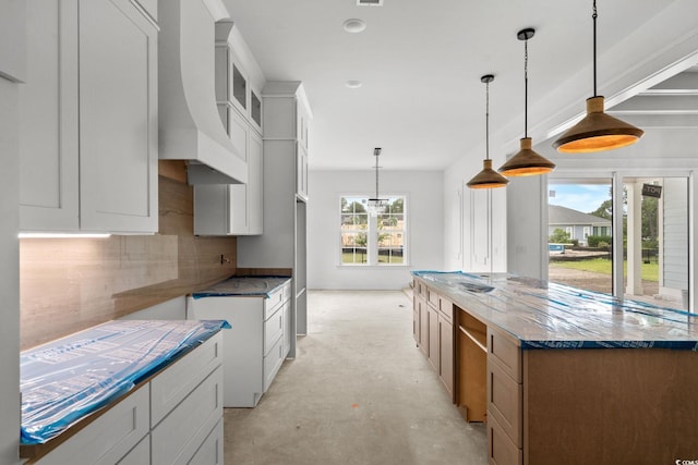 2201 Yellow Morel Way, Myrtle Beach, SC 29579 - kitchen featuring stone countertops, a kitchen island, unfinished concrete flooring, premium range hood, and glass insert cabinets