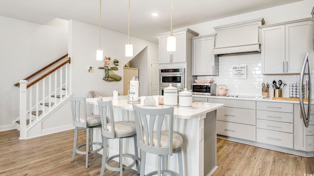 5205 Double Eagle Way Unit 24, North Myrtle Beach, SC 29582 - kitchen featuring appliances with stainless steel finishes, light countertops, light wood-style floors, backsplash, and recessed lighting
