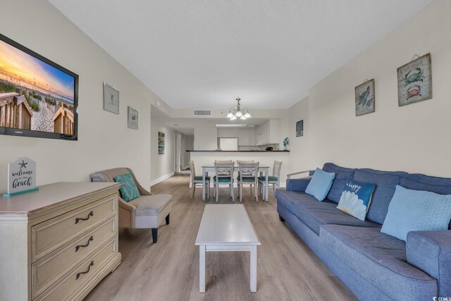 201 74th Ave N Unit 703, Myrtle Beach, SC 29572 - living room featuring a chandelier and light wood-type flooring