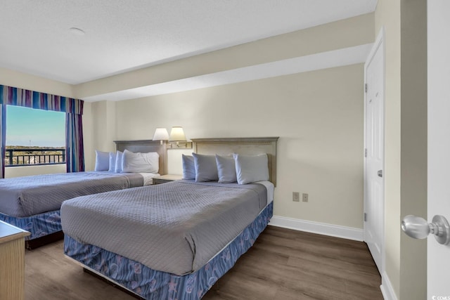 201 74th Ave N Unit 703, Myrtle Beach, SC 29572 - bedroom featuring baseboards and wood finished floors