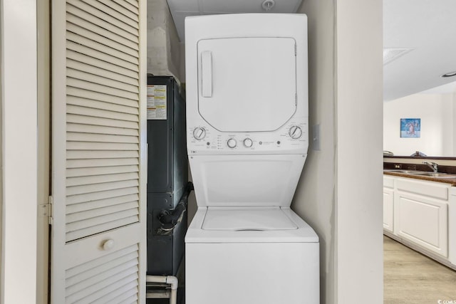 201 74th Ave N Unit 703, Myrtle Beach, SC 29572 - laundry room with stacked washer / dryer and light wood-type flooring
