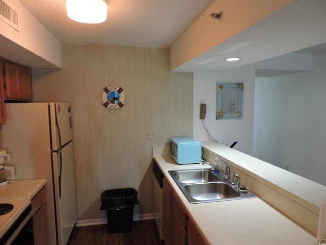 2500 N Ocean Blvd Unit 709, North Myrtle Beach, SC 29582 - kitchen featuring white appliances, light countertops, brown cabinets, dark wood-style flooring, and a peninsula