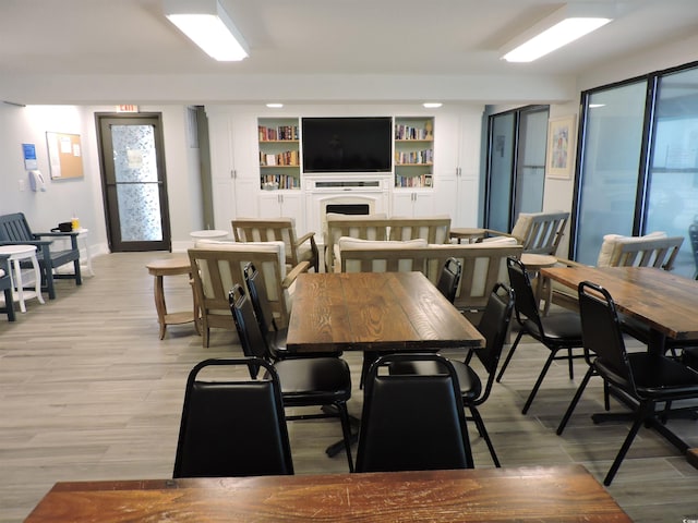 2500 N Ocean Blvd Unit 709, North Myrtle Beach, SC 29582 - dining space with light wood-style floors and a fireplace