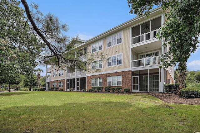 5801 Oyster Catcher Dr Unit 324, North Myrtle Beach, SC 29582 - back of property with brick siding, a lawn, and ceiling fan