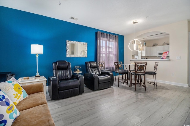 5801 Oyster Catcher Dr Unit 324, North Myrtle Beach, SC 29582 - living room with arched walkways and light wood-style floors