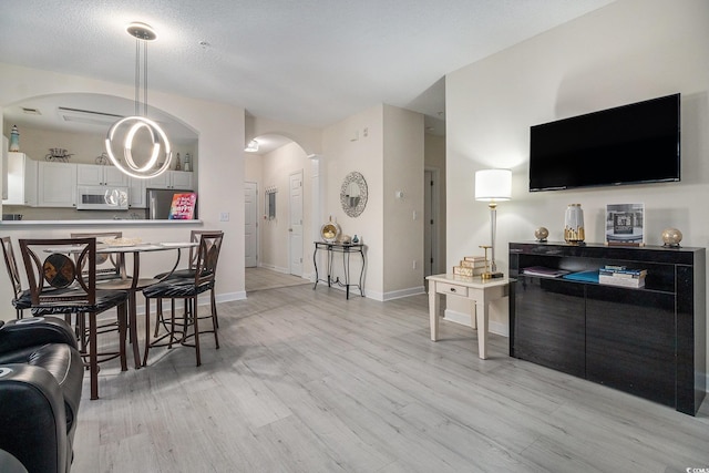 5801 Oyster Catcher Dr Unit 324, North Myrtle Beach, SC 29582 - living room featuring arched walkways and light wood-style flooring