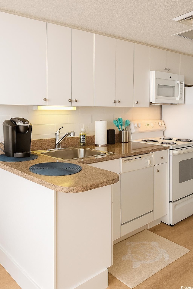 158 Seawatch Dr Unit 910, Myrtle Beach, SC 29572 - kitchen with white appliances, white cabinets, backsplash, and light wood-type flooring