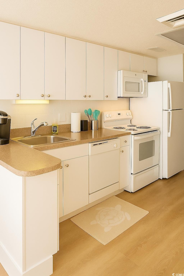 158 Seawatch Dr Unit 910, Myrtle Beach, SC 29572 - kitchen with white appliances, light wood-style floors, white cabinetry, light countertops, and tasteful backsplash