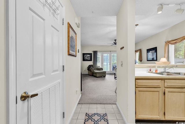 1221 Tidewater Dr Unit 911, North Myrtle Beach, SC 29582 - hall featuring plenty of natural light, light tile patterned floors, and light colored carpet