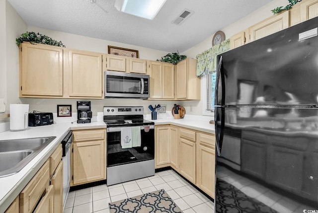 1221 Tidewater Dr Unit 911, North Myrtle Beach, SC 29582 - kitchen featuring appliances with stainless steel finishes, light brown cabinetry, light countertops, and a textured ceiling