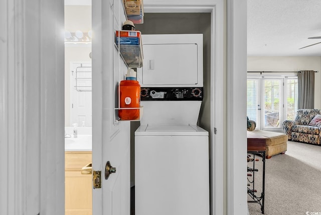 1221 Tidewater Dr Unit 911, North Myrtle Beach, SC 29582 - washroom featuring stacked washer / dryer, ceiling fan, and carpet floors