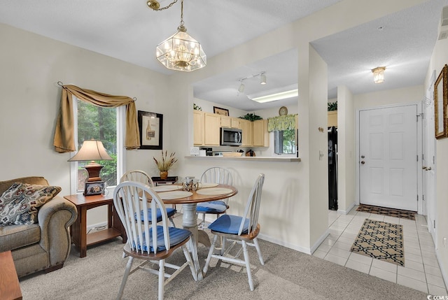 1221 Tidewater Dr Unit 911, North Myrtle Beach, SC 29582 - dining area featuring a chandelier, light tile patterned flooring, and light colored carpet