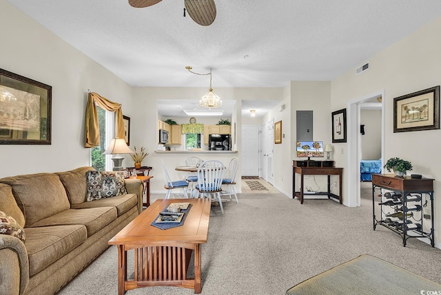 1221 Tidewater Dr Unit 911, North Myrtle Beach, SC 29582 - living area featuring light colored carpet, a textured ceiling, and a ceiling fan