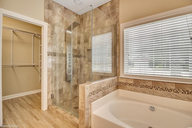 2901 Whooping Crane Dr, North Myrtle Beach, SC 29582 - full bathroom with a bath, a shower stall, a walk in closet, and wood finished floors