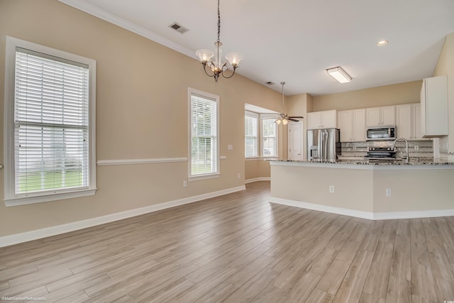 2901 Whooping Crane Dr, North Myrtle Beach, SC 29582 - kitchen featuring stainless steel appliances, tasteful backsplash, light stone countertops, light wood finished floors, and recessed lighting