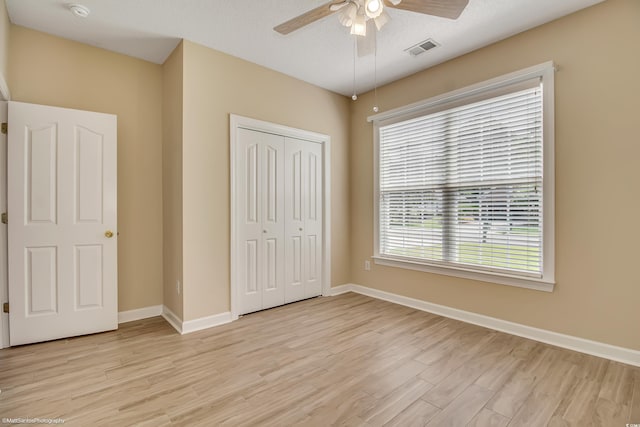 2901 Whooping Crane Dr, North Myrtle Beach, SC 29582 - unfurnished bedroom with light wood-style flooring, a closet, and a ceiling fan