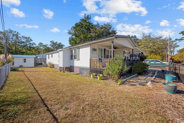817 Wayne St, North Myrtle Beach, SC 29582 - view of front of home featuring a ceiling fan, crawl space, covered porch, and a storage unit