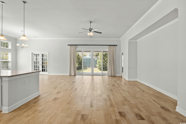 957 Bronwyn Cir N, Myrtle Beach, SC 29582 - unfurnished living room featuring ceiling fan, light wood finished floors, plenty of natural light, crown molding, and a chandelier