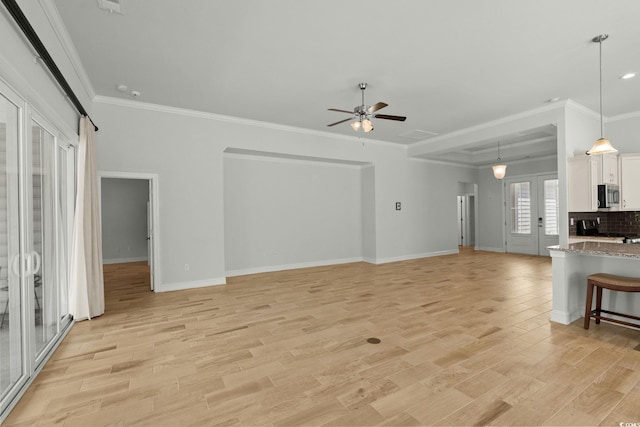 957 Bronwyn Cir N, Myrtle Beach, SC 29582 - unfurnished living room featuring light wood-style flooring, ceiling fan, and ornamental molding