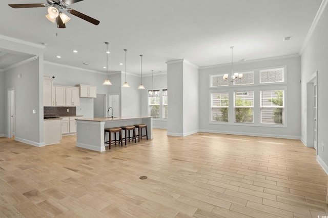 957 Bronwyn Cir N, Myrtle Beach, SC 29582 - unfurnished living room featuring a ceiling fan, recessed lighting, light wood-type flooring, a chandelier, and ornamental molding