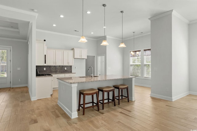 957 Bronwyn Cir N, Myrtle Beach, SC 29582 - kitchen with light wood-type flooring, decorative backsplash, recessed lighting, light stone countertops, and white cabinets