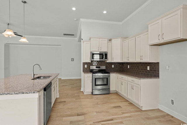 957 Bronwyn Cir N, Myrtle Beach, SC 29582 - kitchen featuring appliances with stainless steel finishes, crown molding, light stone countertops, decorative backsplash, and light wood-style floors