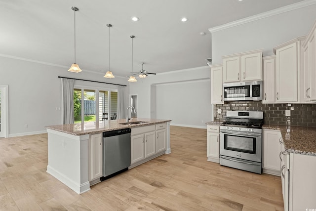 957 Bronwyn Cir N, Myrtle Beach, SC 29582 - kitchen featuring stainless steel appliances, ornamental molding, backsplash, an island with sink, and light stone countertops