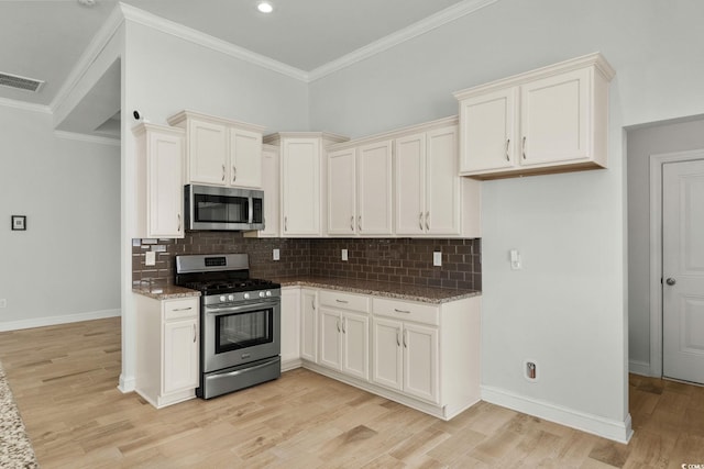 957 Bronwyn Cir N, Myrtle Beach, SC 29582 - kitchen with stainless steel appliances, light stone countertops, light wood-style flooring, backsplash, and ornamental molding
