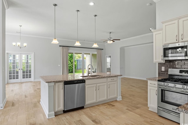 957 Bronwyn Cir N, Myrtle Beach, SC 29582 - kitchen with stainless steel appliances, light wood-style floors, backsplash, a ceiling fan, and light stone countertops