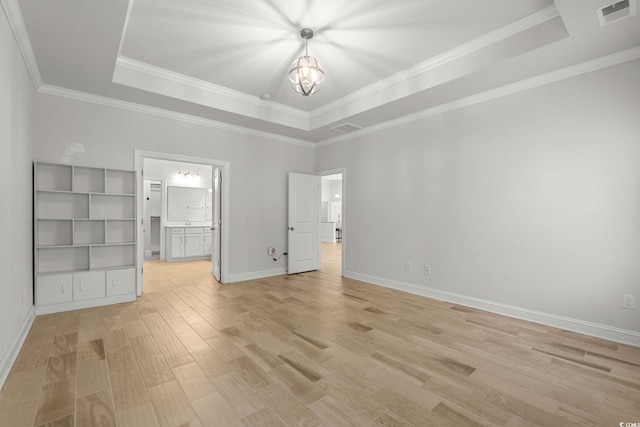 957 Bronwyn Cir N, Myrtle Beach, SC 29582 - unfurnished bedroom with a raised ceiling, a chandelier, light wood-style flooring, ornamental molding, and ensuite bath