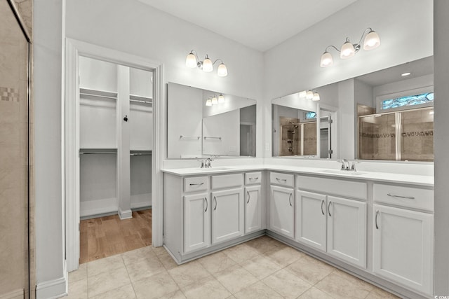 957 Bronwyn Cir N, Myrtle Beach, SC 29582 - bathroom featuring a walk in closet, double vanity, and a stall shower