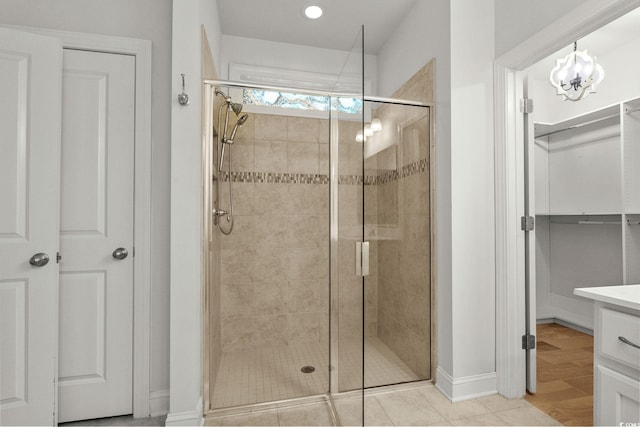 957 Bronwyn Cir N, Myrtle Beach, SC 29582 - bathroom featuring a stall shower, a chandelier, vanity, a walk in closet, and recessed lighting