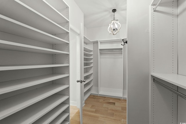 957 Bronwyn Cir N, Myrtle Beach, SC 29582 - spacious closet featuring light wood-style floors and a chandelier