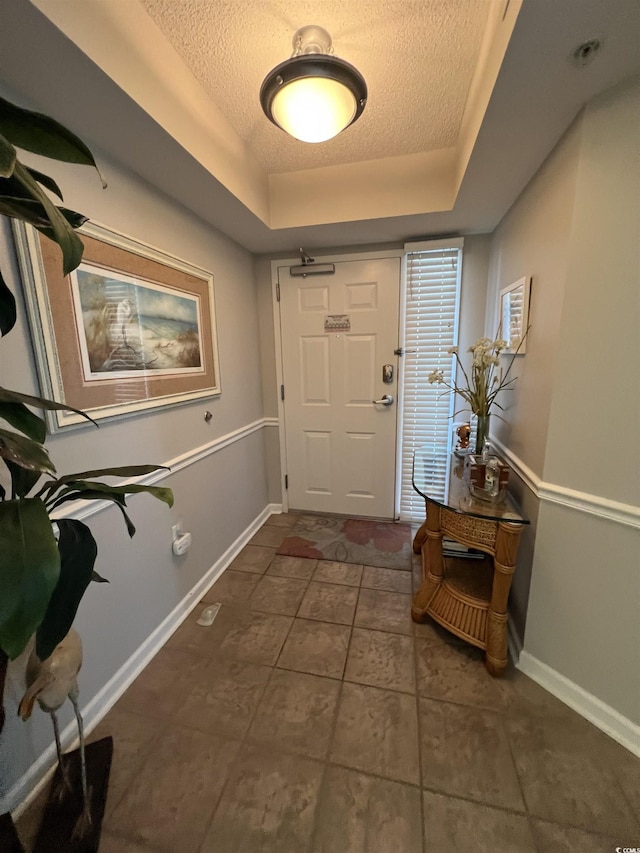 1401 S Ocean Blvd Unit 1307, North Myrtle Beach, SC 29582 - foyer featuring a textured ceiling, a tray ceiling, and dark tile patterned floors
