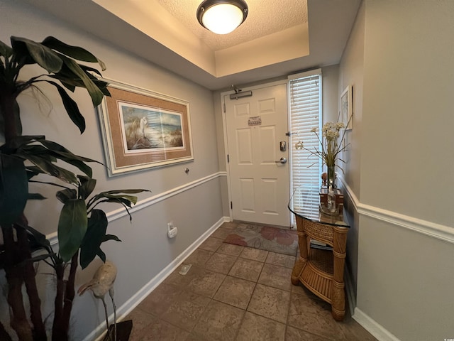 1401 S Ocean Blvd Unit 1307, North Myrtle Beach, SC 29582 - entrance foyer featuring a textured ceiling, dark tile patterned flooring, and a tray ceiling
