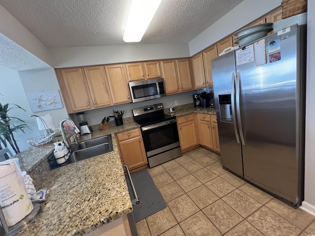 1401 S Ocean Blvd Unit 1307, North Myrtle Beach, SC 29582 - kitchen featuring stainless steel appliances, a textured ceiling, a peninsula, light tile patterned floors, and light stone countertops