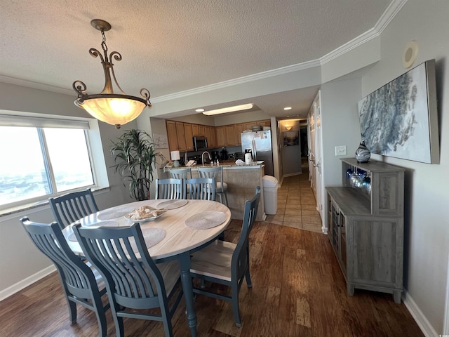 1401 S Ocean Blvd Unit 1307, North Myrtle Beach, SC 29582 - dining area with ornamental molding, a textured ceiling, and wood finished floors