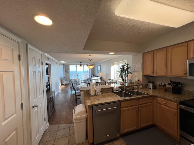 1401 S Ocean Blvd Unit 1307, North Myrtle Beach, SC 29582 - kitchen with stainless steel appliances, a peninsula, open floor plan, a textured ceiling, and crown molding