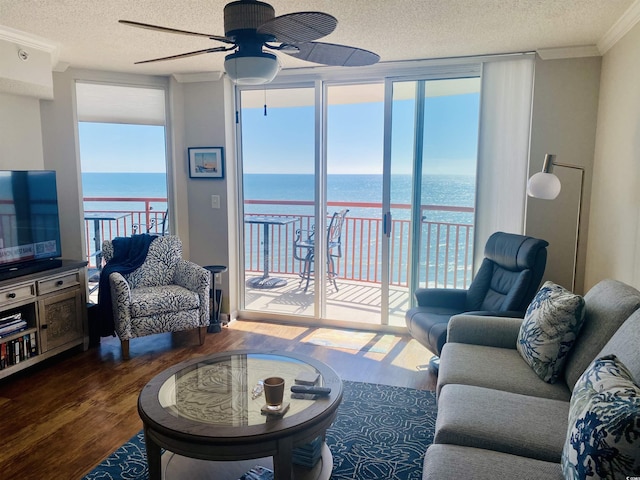 1401 S Ocean Blvd Unit 1307, North Myrtle Beach, SC 29582 - living room with wood finished floors, a ceiling fan, a textured ceiling, ornamental molding, and healthy amount of natural light