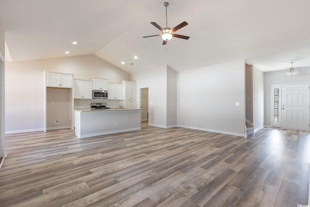 442 Lifestyle Ct, Surfside Beach, SC 29575 - unfurnished living room with a ceiling fan, light wood-style flooring, high vaulted ceiling, and recessed lighting