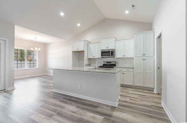 442 Lifestyle Ct, Surfside Beach, SC 29575 - kitchen featuring appliances with stainless steel finishes, a chandelier, white cabinetry, decorative backsplash, and light wood-type flooring
